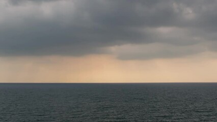 Wall Mural - dramatic sky with storm cloud on a cloudy day time lapse at the ocean.