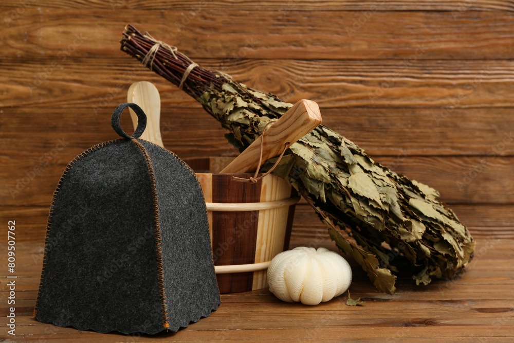 Different accessories for sauna on wooden background