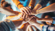 © AtoZ Studio - Group of people stacking hands in the middle. Background for teamwork.