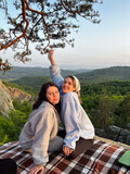 Fototapeta Miasto - happy couple women friends taking picture on sunset