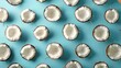 © Hryhor Denys - A collection of coconut halves neatly arranged on a table with a blue background