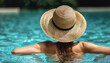 Woman wearing sun hat relaxing in swimming pool