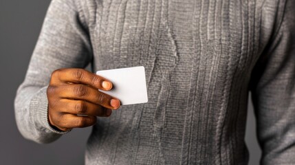 Close up of an African American mans hand holding a piece of paper