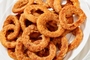 Sticker - deep fried crispy onion rings on white plate