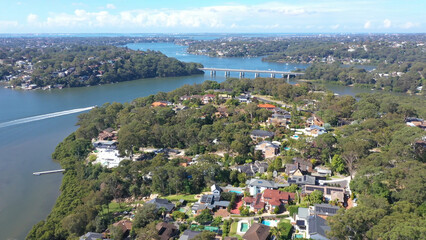 Wall Mural - Aerial drone view above Illawong in the Sutherland Shire, South Sydney, NSW Australia on a sunny day in April 2024 looking toward Como Bridge 