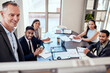 © peopleimages.com - Business, man and boardroom with meeting for teamwork, collaboration and feedback on company growth as leader. Ceo, boss and people at office with smile for strategy, report and progress as partner