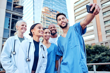Poster - Group, doctors and phone with selfie in city for profile picture, together with smile for social media. Medical, team or photo with diversity in urban with internet, working in healthcare or hospital