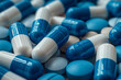 Close-up blue and white capsules and pills. Concept of opioid addiction or health care.