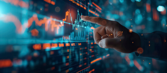 Poster - Banner, A hand pointing at a graph on a computer monitor screen. The graph is filled with numbers and lines, and the hand is hovering over a specific point. Concept of focus and attention to detail