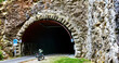 fat bicycle parked at the entrance of a stone tunnel