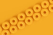 Isometric view of glazed donut with sprinkles on plain monochrome yellow color