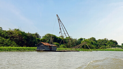 Wall Mural - fisherman boat on the tonle sap river in cambodia