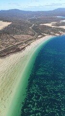 Sticker - Picturesque beach landscape with a sandy coastline and clear water in Tasmania, Australia.