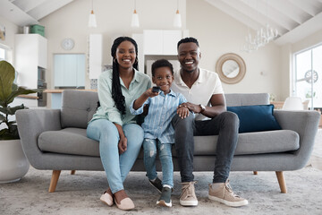 Wall Mural - Portrait, African family and smile for remote, mother and father with son, watch and television in lounge. Home, woman and man with boy, movies or film with subscription, relax and happy in weekend