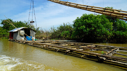 Wall Mural - fisherman boat on the tonle sap river in cambodia