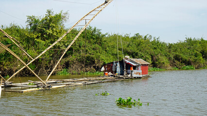 Wall Mural - fisherman boat on the tonle sap river in cambodia