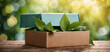 Box with leaves on a wooden table, concept of earth and recycling.