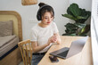 © Q88 - Portrait of asian girl working at home