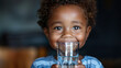 © Miljan Živković - Portrait of african american boy child toddler stand and hold glass of water