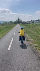 Wall Mural - Happy family, children boys and adults, riding bikes together on a summer sunny day