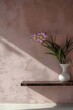 Ethereal Morning in a Serene Garden Nook: Soft Pink Wall with Floral Themes and Gentle Light Flares for Advertisement Mockup