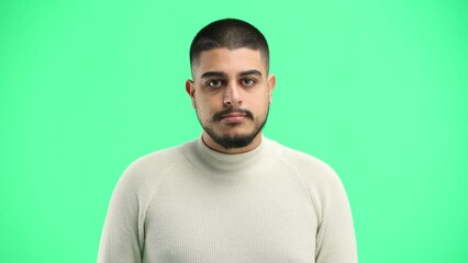 Canvas Print - A man, close-up, on a green background, tells a secret