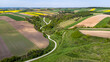 Grodzisko Stradow medieval settlement and curvy countryside road in Ponidzie region of Poland. Drone view