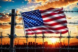 Fototapeta Do przedpokoju - A red, white, and blue American flag is flying over a barbed wire fence