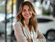 Portrait of beautiful business person smiling consultant in car salon. Car dealer in showroom