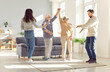 Whole family old parents adult children funny dancing in living room laughter and smiling. Family funny dancing at home old parents adult children rhythm of family unity with happy funny dancing