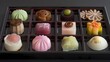 A box of assorted intricately designed chocolates and confections