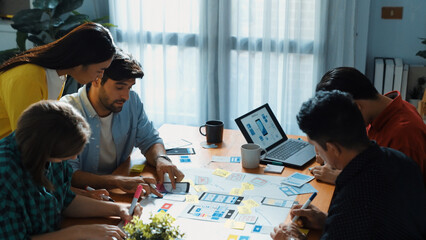 Top view of professional business team brainstorming and sharing idea by using mind map. Diverse people planning marketing strategy or designing Ux Ui design for mobile phone at meeting. Convocation.