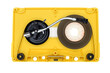 Turntable arm on old yellow audio cassette tape open