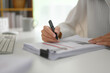 Closeup businesswoman writing strategy ideas on paper at office desk