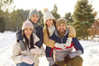Happy family winter portrait, vacation, spending weekend outdoor, parent, children enjoy holiday together. Friendly smiling to celebrate New Year, Christmas holiday season amusement, nature recreation