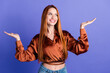 Photo of pretty young woman look arms hold empty space wear brown shirt isolated on violet color background