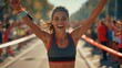 © Антон Сальников - An athletic female jogger crosses the finish line with cheers from her audience during a marathon race. She is happy, confident and empowered after winning.
