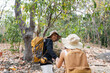 © itchaznong - Happy LGBT Lesbian couple Travelers Hiking with Backpacks in waterfall Trail. LGBT Lesbian Couple Hikers with backpacks walks in mountains in vacation