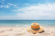 Straw hat on a beach sand, ocean background with copy space, holiday and vacation concept