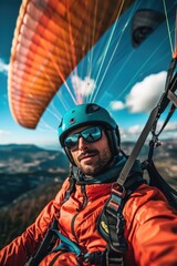 Sticker - A man wearing a red jacket and a blue helmet is flying a parachute