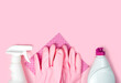 Detergent, cleaner, rubber gloves and cleaning sponge on a pink background. Flatlay. Close-up. Top view. Copy space.