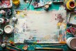 An overhead view of a table covered in various paint colors and a multitude of paintbrushes scattered around