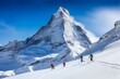 Group of skiers hike up a pristine snow-covered slope with a majestic mountain peak in the background