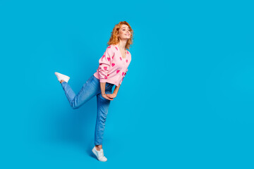 Wall Mural - Full body photo of pretty young girl look excited girlish empty space wear trendy pink outfit isolated on blue color background