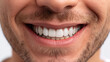 A close-up image of a man's confident smile, showcasing healthy white teeth and subtle facial hair details, perfect for dental hygiene and beauty projects