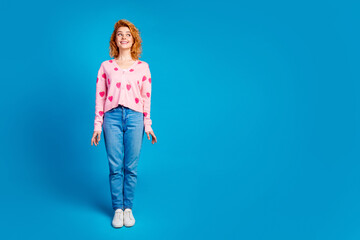 Wall Mural - Full length photo of attractive young woman posing model look empty space dressed stylish pink clothes isolated on blue color background