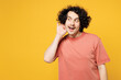 Young curious nosy happy man he wear pink t-shirt casual clothes try to hear you overhear listening intently look aside isolated on plain yellow orange background studio portrait. Lifestyle concept.