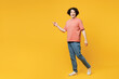 Full body young shocked surprised happy man he wear pink t-shirt casual clothes walk go point index finger aside on area isolated on plain yellow orange background studio portrait. Lifestyle concept.
