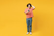 Full body young shocked surprised amazed happy man he wears pink t-shirt casual clothes hold head use mobile cell phone isolated on plain yellow orange background studio portrait. Lifestyle concept.