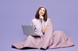 Full body young minded IT woman she wear pyjamas jam sleep eye mask rest relax at home sit wrapped blanket hold use laptop pc computer isolated on plain purple background. Good mood night nap concept.